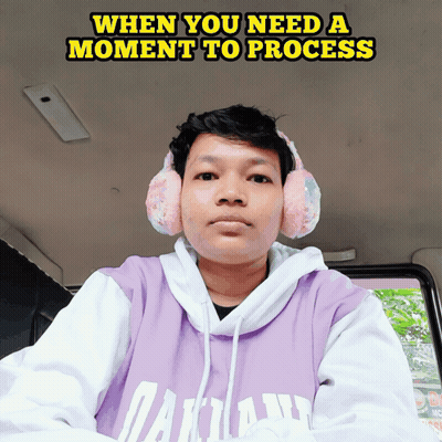 A Man Wearing Headphones And A Purple Hoodie With The Words When You Need A Moment To Process GIF