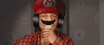 A Man Wearing Headphones And A Red Hat With A M On It GIF