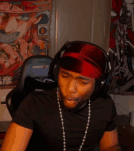 A Man Wearing Headphones And A Red Headband Has The Letter O On His Head GIF