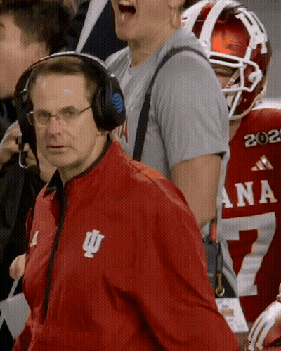 A Man Wearing Headphones And A Red Jacket With The Letters Iu On It GIF