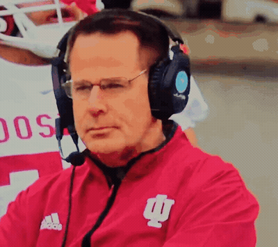 A Man Wearing Headphones And A Red Jacket With The Word Adidas On It GIF