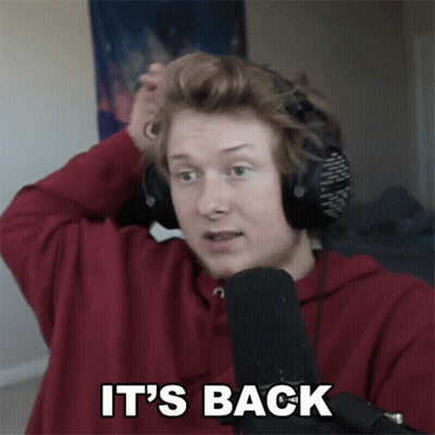 A Man Wearing Headphones And A Red Shirt Says It 'S Back In Front Of A Microphone GIF