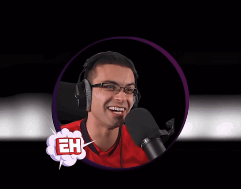 A Man Wearing Headphones And A Red Shirt That Says Eh On It Stands In Front Of A Microphone GIF