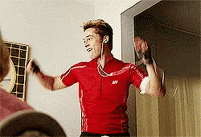 A Man Wearing Headphones And A Red Shirt With The Letter S On The Front GIF