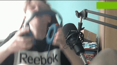 A Man Wearing Headphones And A Reebok Shirt GIF