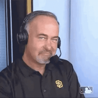 A Man Wearing Headphones And A San Diego Padres Shirt Is Making A Face . GIF