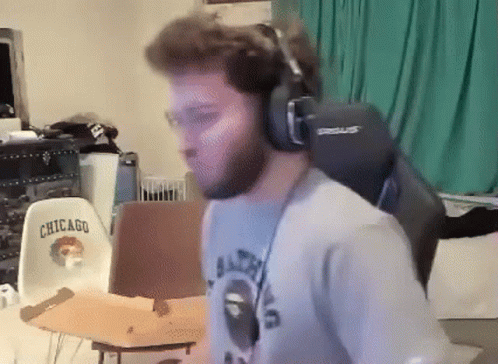 A Man Wearing Headphones And A Shirt That Says Chicago On It GIF