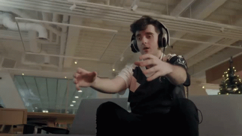 A Man Wearing Headphones And A Shirt That Says ' Nc ' On It GIF