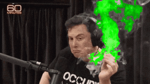 A Man Wearing Headphones And A Shirt That Says Occupy Is Smoking A Cigarette GIF