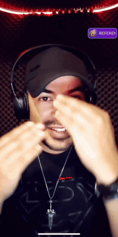 A Man Wearing Headphones And A Shirt That Says Superman Is Making A Face GIF