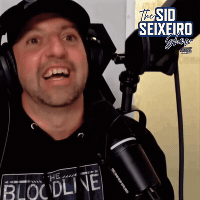 A Man Wearing Headphones And A Shirt That Says The Bloodline GIF