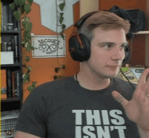 A Man Wearing Headphones And A Shirt That Says This Isn't GIF