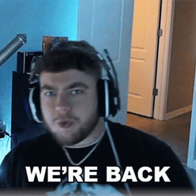 A Man Wearing Headphones And A Shirt That Says We 'Re Back . GIF