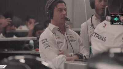 A Man Wearing Headphones And A Shirt With Petronas On It GIF