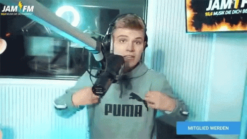 A Man Wearing Headphones And A Sweatshirt That Says Puma GIF