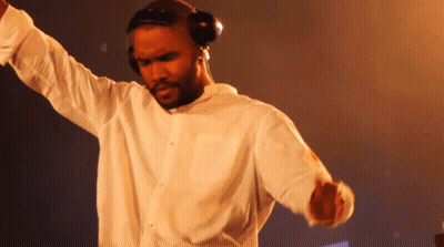 A Man Wearing Headphones And A White Shirt Dancing GIF