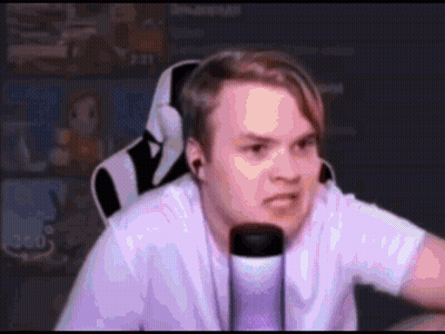 A Man Wearing Headphones And A White Shirt Is Sitting In Front Of A Microphone And Making A Funny Face . GIF
