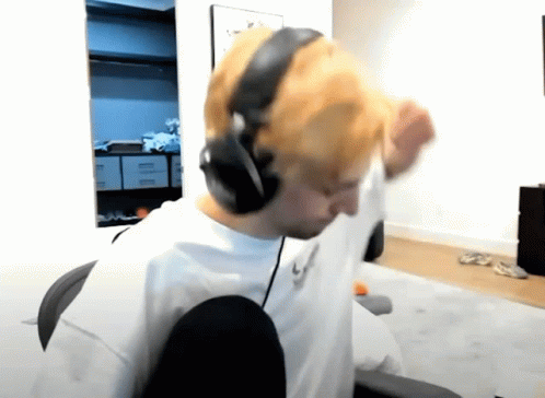 A Man Wearing Headphones And A White Shirt With The Letters L On It GIF