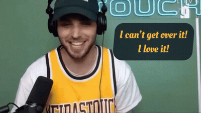A Man Wearing Headphones And A Yellow Jersey Says I Can 'T Get Over It And I Love It GIF