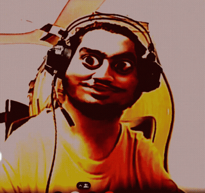A Man Wearing Headphones And A Yellow Shirt Is Looking At Something GIF