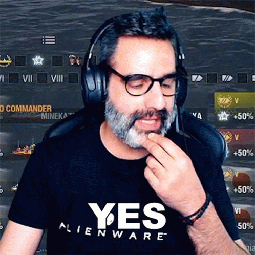 A Man Wearing Headphones And A Yes Alienware Shirt Is Playing A Video Game . GIF