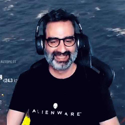 A Man Wearing Headphones And An Alienware Shirt GIF