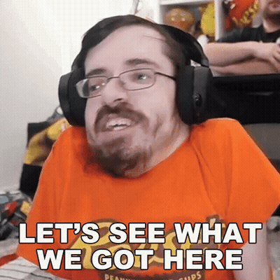 A Man Wearing Headphones And An Orange Shirt With The Words Let 'S See What We Got Here GIF