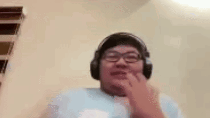A Man Wearing Headphones And Glasses Is Making A Funny Face With His Mouth Open . GIF