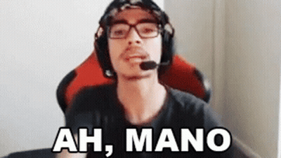 A Man Wearing Headphones And Glasses Is Sitting In A Chair And Talking Into A Microphone . GIF