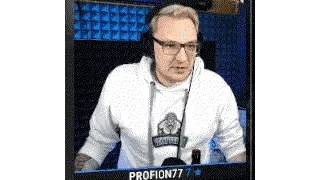 A Man Wearing Headphones And Glasses Is Sitting In Front Of A Microphone In A Room . Sticker