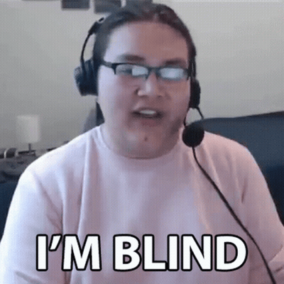 A Man Wearing Headphones And Glasses Is Talking Into A Microphone . GIF