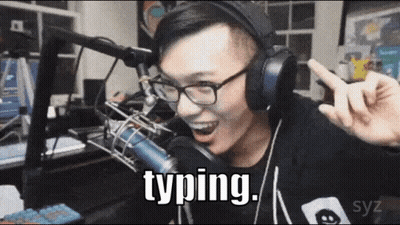A Man Wearing Headphones And Glasses Is Typing In Front Of A Microphone GIF