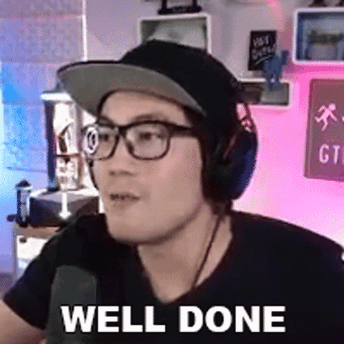 A Man Wearing Headphones And Glasses Says Well Done . GIF