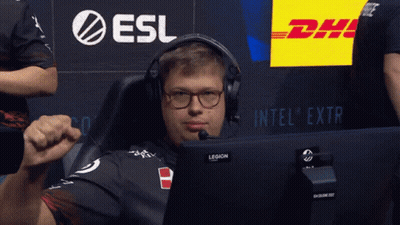 A Man Wearing Headphones And Glasses Sits In Front Of A Dhl Sign GIF