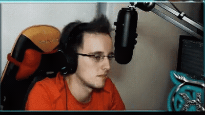 A Man Wearing Headphones And Glasses Sitting In Front Of A Microphone . GIF
