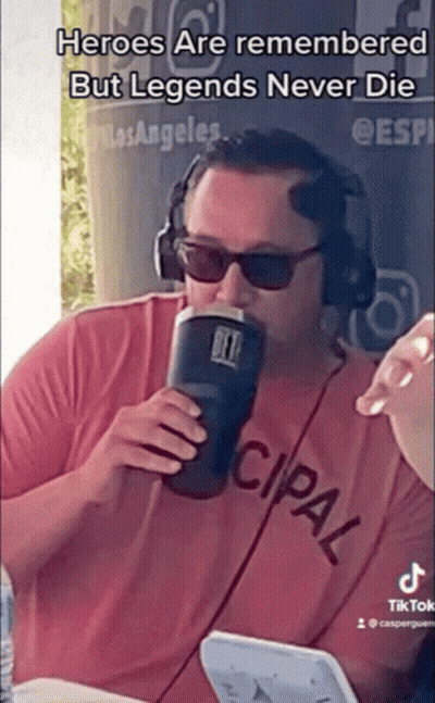 a man wearing headphones and sunglasses drinking from a yeti cup