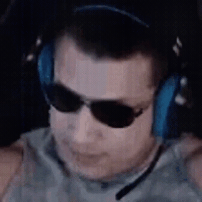 A Man Wearing Headphones And Sunglasses Is Sitting In Front Of A Computer Screen . GIF