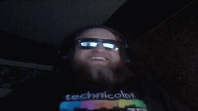 A Man Wearing Headphones And Sunglasses Is Wearing A Technicolor T-Shirt GIF