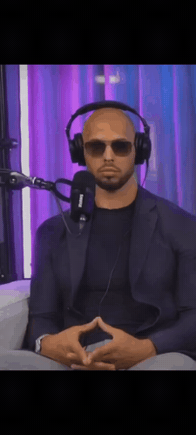 A Man Wearing Headphones And Sunglasses Sitting In Front Of A Microphone . GIF