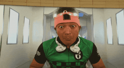 A Man Wearing Headphones Around His Neck And A Pink Headband With The Number 6 On It GIF