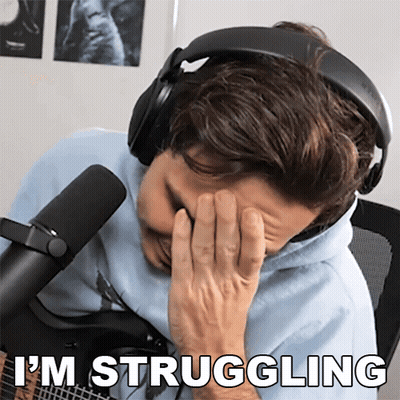 A Man Wearing Headphones Covering His Face With His Hand And The Words " I 'M Struggling " Behind Him GIF