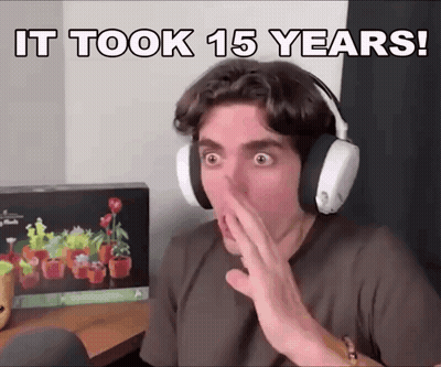A Man Wearing Headphones Covering His Mouth With His Hand With The Words It Took 15 Years Written Above Him GIF