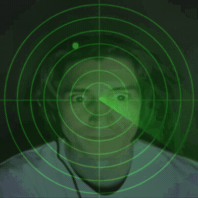 A Man Wearing Headphones Is Being Monitored By A Green Radar Screen GIF