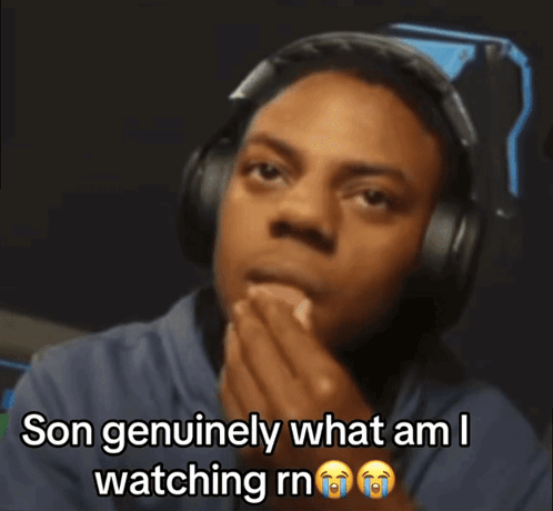 A Man Wearing Headphones Is Covering His Mouth And Says Son Genuinely What Am I Watching Rn GIF