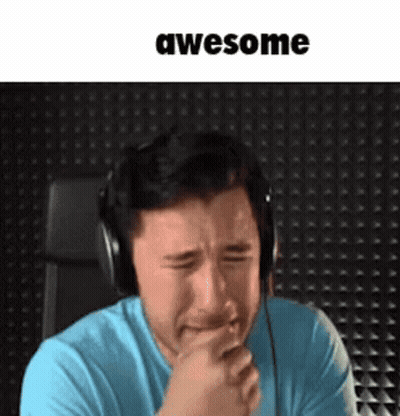 A Man Wearing Headphones Is Crying While Holding His Hand To His Mouth . GIF