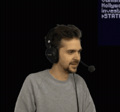 A Man Wearing Headphones Is Dancing In Front Of A Screen That Says " Hollywood Invests " GIF