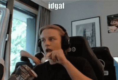 A Man Wearing Headphones Is Eating Chips While Sitting In A Chair In Front Of A Window . GIF