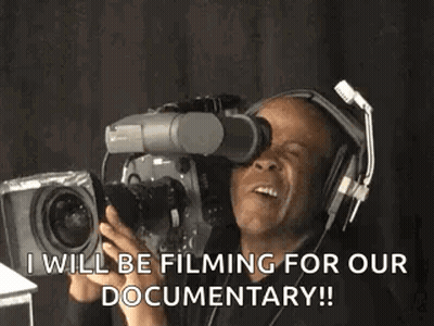 A Man Wearing Headphones Is Holding A Camera And Says I Will Be Filming For Our Documentary GIF
