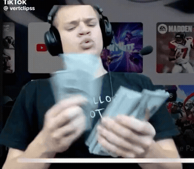 A Man Wearing Headphones Is Holding A Stack Of Money In His Hands GIF