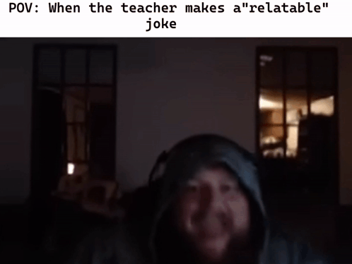 A Man Wearing Headphones Is Laughing In A Dark Room With The Caption When The Teacher Makes A " Relatable " Joke GIF